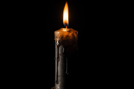 Candle with honey on dark background, closeup. Space for textの素材