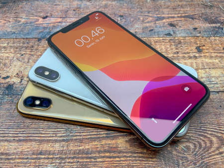 BALI, INDONESIA JUNE 29, 2020: Iphone Xs It has been used on a table with a wooden texture, top view. latest iphone products.のeditorial素材