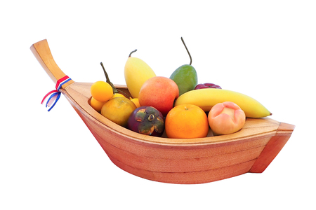 Artificial fruit in a small boat fabricated in thailandの写真素材