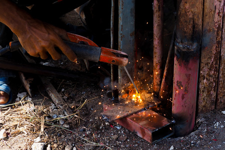 Arc welding and welding fumes, Worker welding on steel in the job site.の写真素材