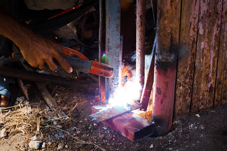 Arc welding and welding fumes, Worker welding on steel in the job site.の写真素材