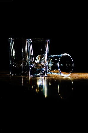 three glasses on the bar in a beam of lightの写真素材
