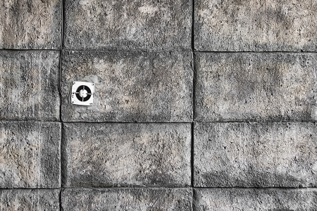 one fan in the wall of rough blocksの写真素材