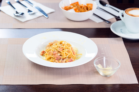 Italian pasta bolognese with bacon on a plateの写真素材