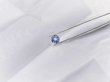 Blue Tanzanite Gemstone in Tweezersの写真素材