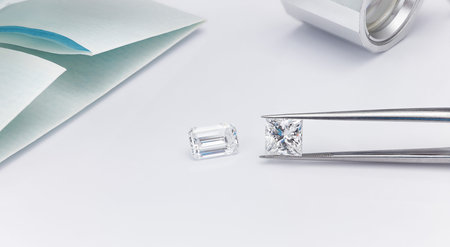 Loose Diamonds Held in Tweezers