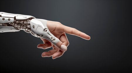 Close up of robot hand pointing at something on dark background. The concept of artificial intelligence, aiの素材