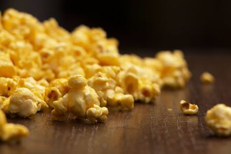  close up pop corn on a dark brown table, focus on foreground leftの写真素材
