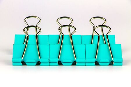 Green paper clips on white background.の写真素材