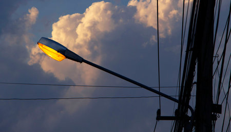 Street lamp on electricity post with twilight background.