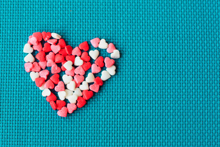 Candy Valentines Hearts. Valentine day background with red hearts, top view. Valentines card