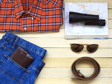 Mens casual outfits with man clothing, travel preparations and accessories on wooden backgroundの写真素材