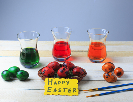 Quail eggs in the process of drawing with colorful food paint red, green and orange. Easter concept. Happy Easter.の写真素材
