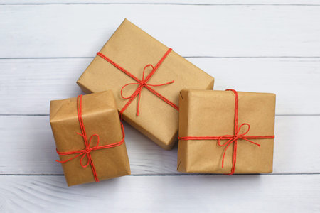 Handcrafted gifts with red twine on white wood bakground, Natural deisgn. Gift box, Delivery box.