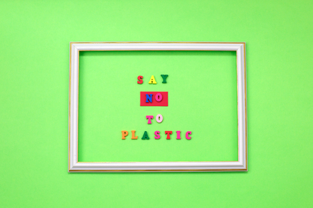 Say NO to plastic - on wooden letters on green background. Environmental, pollution concept. Ban single use plastic.の写真素材