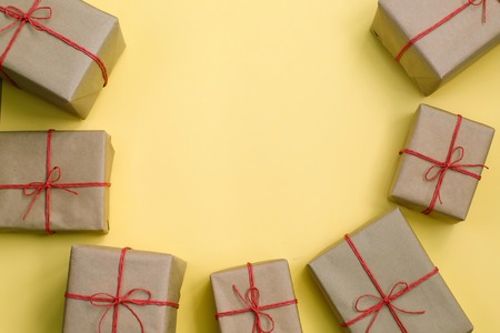 Handcrafted gifts with red twine on yellow bakground, Gift box, Delivery box. Copy spaseの写真素材