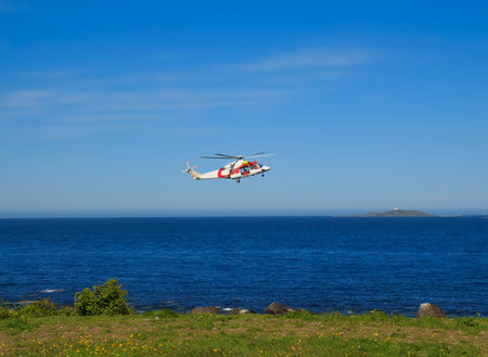 Helicopter over the sea at Godoy island near Alesund, Norway on the west coast of Norway.