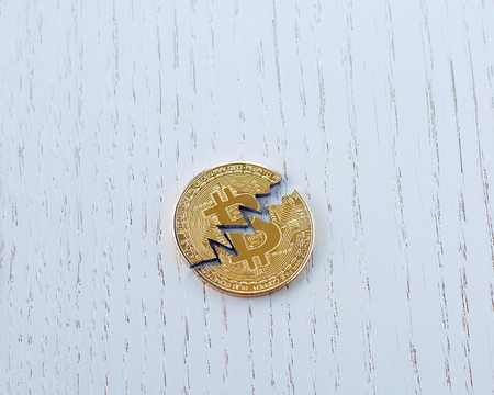 Broken Bitcoin, cryptocurrency falling and rising. Coin bitcoin is broken in half. The fall and collapse of the course of the crypto currencyの写真素材