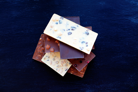 Chocolate on black background. Chocolate bar. Nut chocolate. Sweet backgroundの写真素材