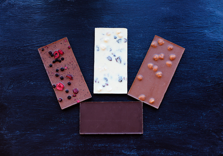 Chocolate on black background. Chocolate bar. Nut chocolate. Sweet backgroundの写真素材