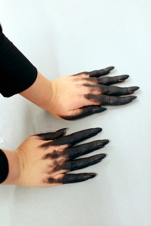 Halloween vampire. Hands with scary manicure. halloween nail. Black polishの写真素材