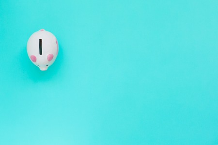 Piggy bank isolated on aquamarine background. Money concept.の写真素材