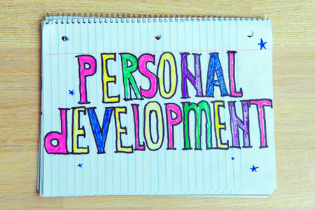Personal Development text written on a notebook on wooden background. Business concept for List Plan...