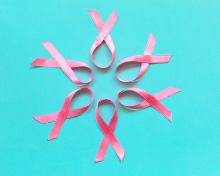 Pink ribbon on a blue background. Pink tape as symbol of women illness mammary cancer. Cancer conceptの写真素材