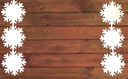 Artificial snowflakes on old wooden background Winter holidays concept. Christmas background.の写真素材