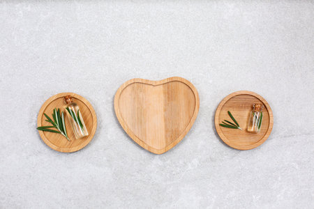 Fresh rosemary and essential oil with fresh rosemary twigs on a light background. Organic cosmetics...