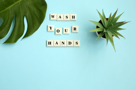 The inscription WASH YOUR HANDS on a blue background. Motivational quote. Coronavirus related image....