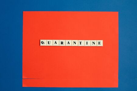 QUARANTINE word written on plastic block on color backgraund.の写真素材