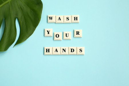 The inscription WASH YOUR HANDS on blue background. Motivational quote. Disease prevention.