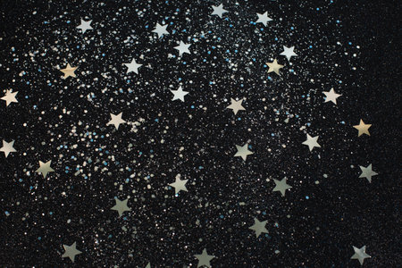Christmas Silver stars and circles glitter on black background. Design element. Silver grainy abstract texture on a black background.の写真素材
