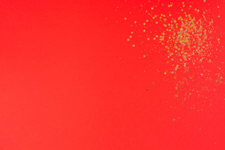 Christmas Gold glitter on red background. Holiday abstract textureの写真素材