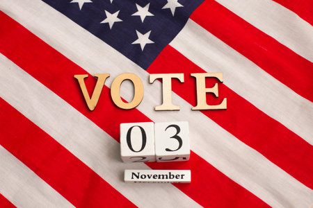 Word VOTE on the United states flag. Presidential election 2020 in the USA. Flat lay composition.の写真素材