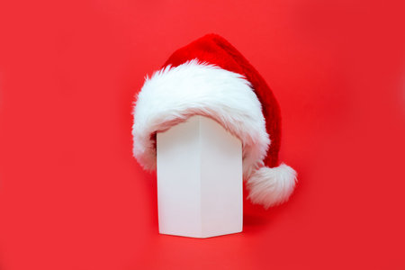 Santa claus hat with geometric shape on blue background. New Year or Christmas minimal concept. Christmas New Year flat lay. creativeの写真素材