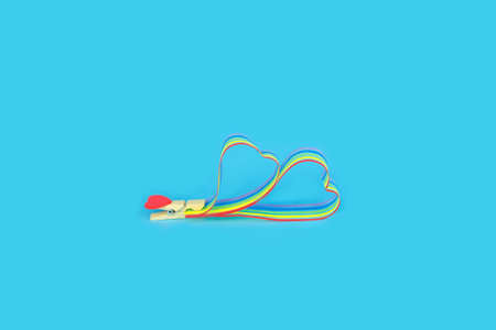 Rainbow ribbon awareness for LGBT community on blue background