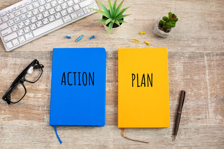 Two colored notebooks with the inscription Action and plan
