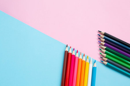 Rainbow bright colored pencils on creative colored background.