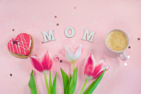 Wooden letters in the phrase MOM with flowers, cookie and coffeeの写真素材