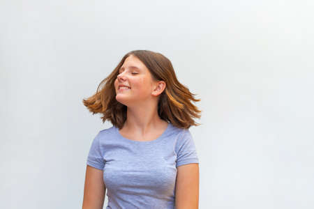 Portrait of beautiful caucasian teenager girl with flying hairの写真素材