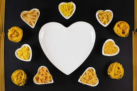 Pasta food selection around heart shaped porcelain dishesの写真素材