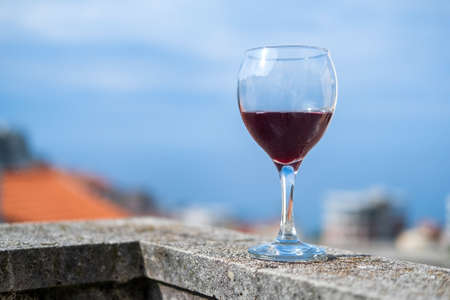 a glass of cold red wine on the balcony againstの写真素材