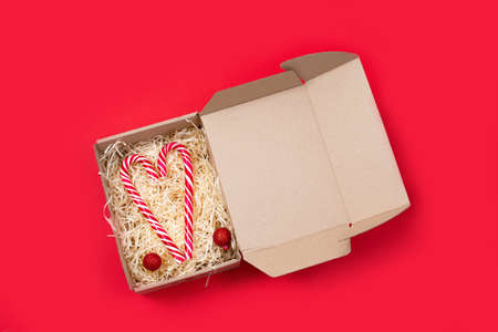 Heart shaped christmas candies candy cane in open gift box.の写真素材