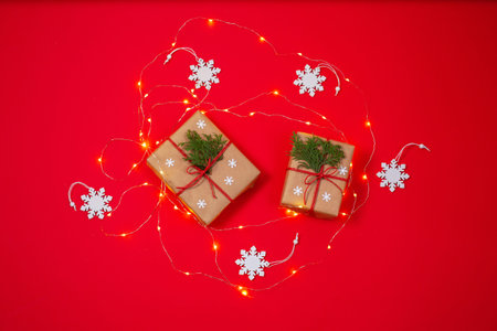 Two gift boxes surrounded by snowflakes and christmas light
