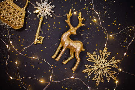 Golden christmas decorative toys on festive black background.の写真素材