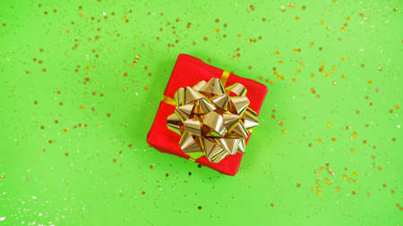 Gift or present box and confetti on green Festive backdropの写真素材
