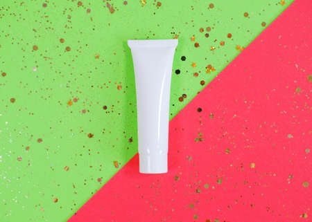 White cosmetic products tube with glittering stars confettiの写真素材