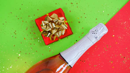 Champagne bottle and gift box on Festive background.の写真素材